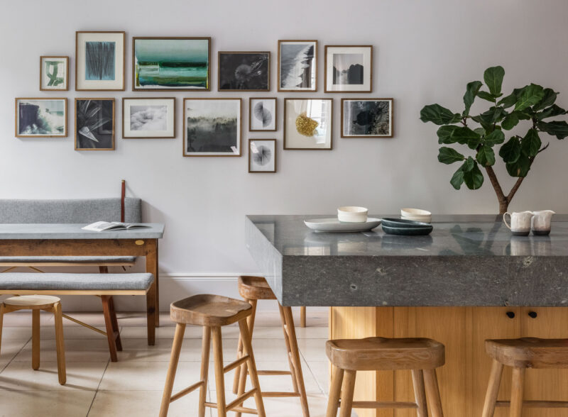 breakfast bar with high stools and photo wall