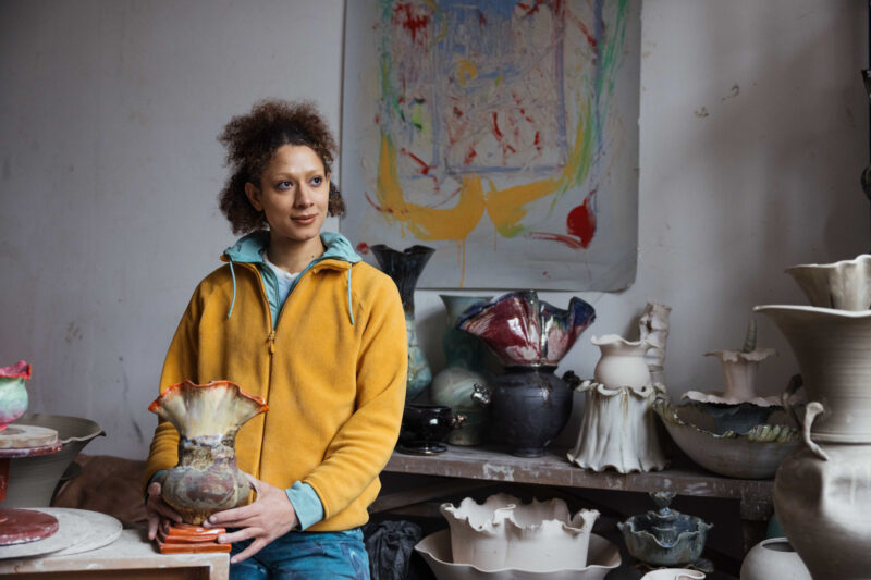 lady holding pottery in studio