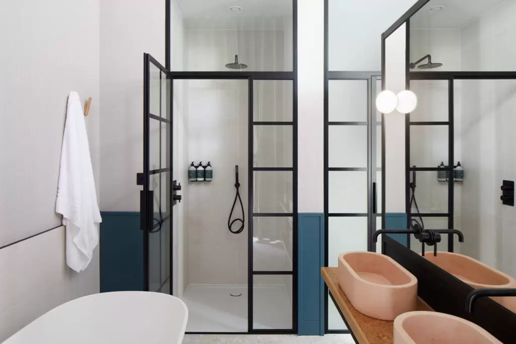 inhabit hotel bathroom with peach sinks