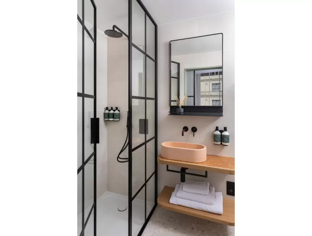 inhabit hotel bathroom with black lined shower screens