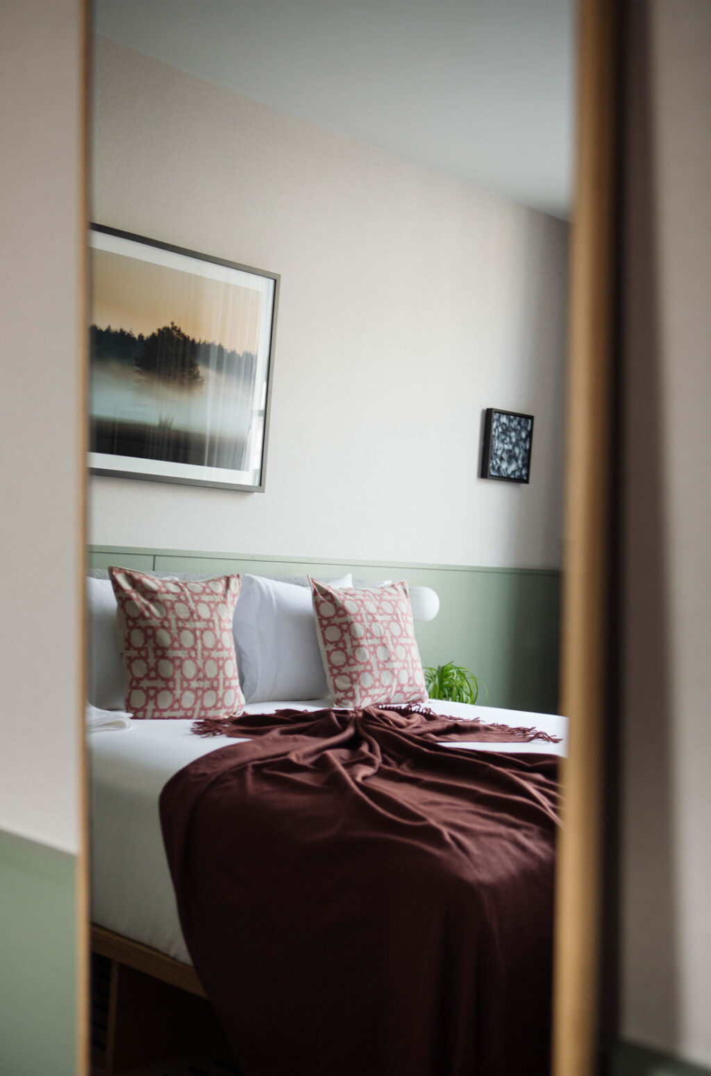 hotel bedroom with burgundy blanket