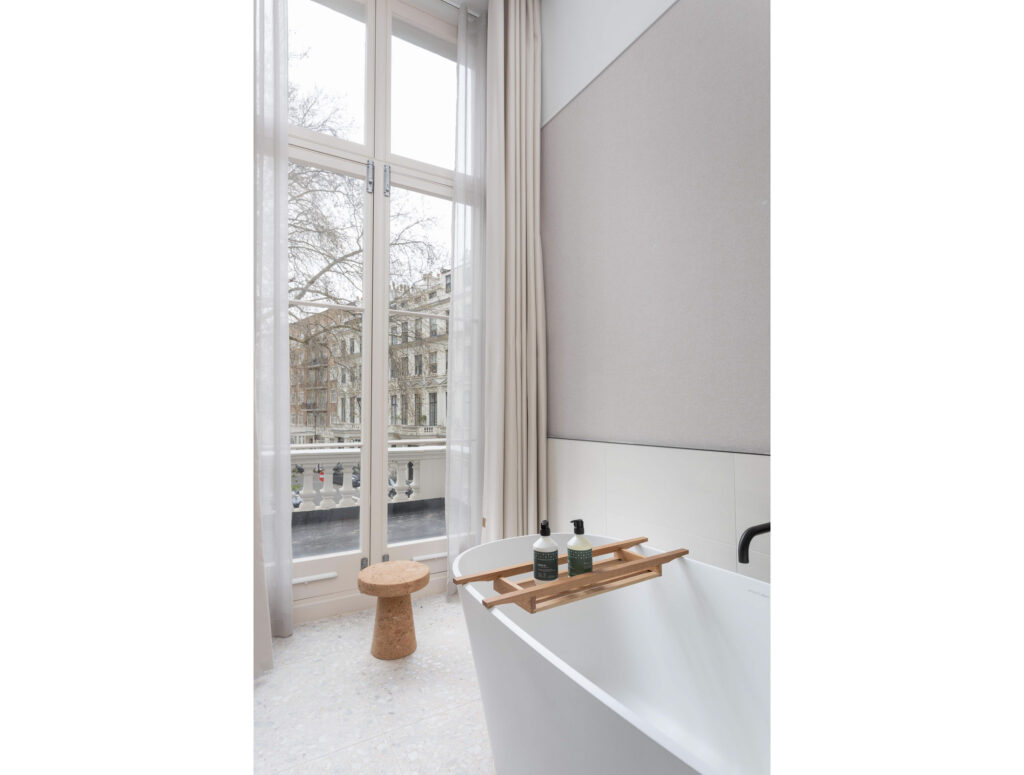 inhabit hotel bathroom with view of london on balcony