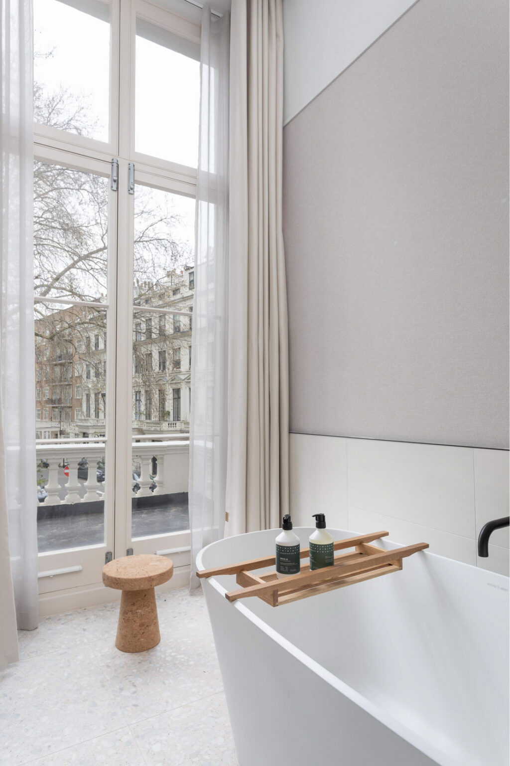 inhabit hotel bathroom with view of london on balcony