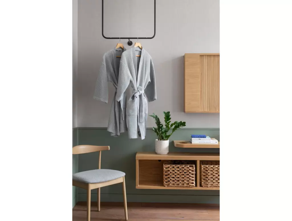 inhabit hotel bedroom with two hanging grey robes