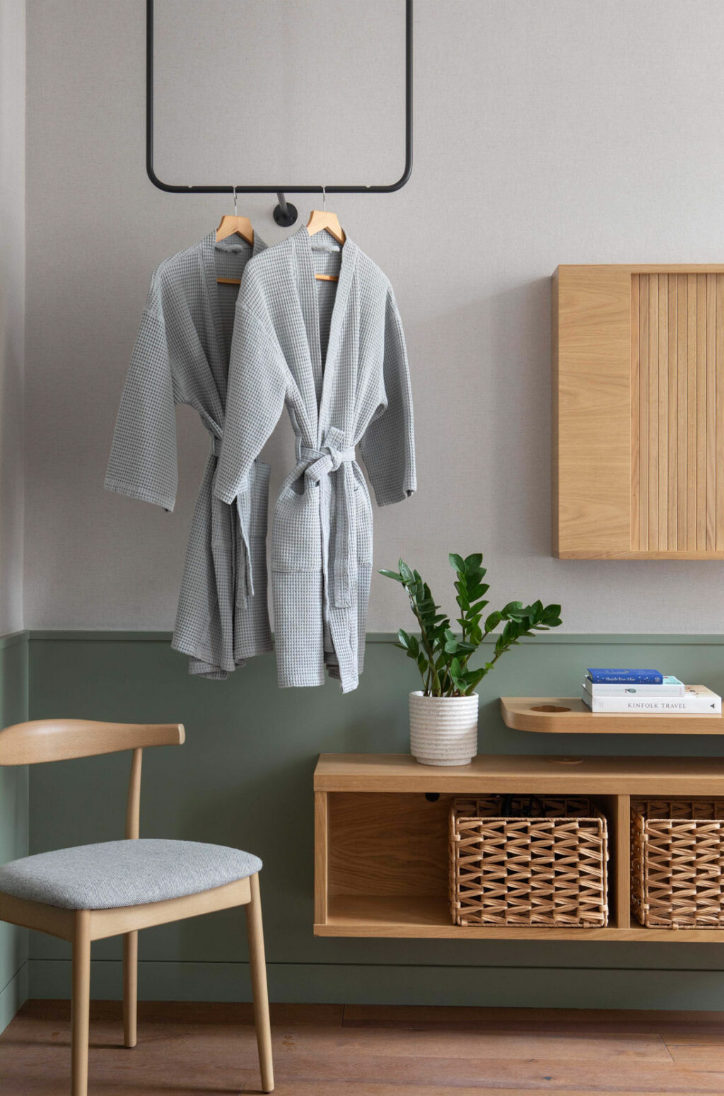 inhabit hotel bedroom with two hanging grey robes