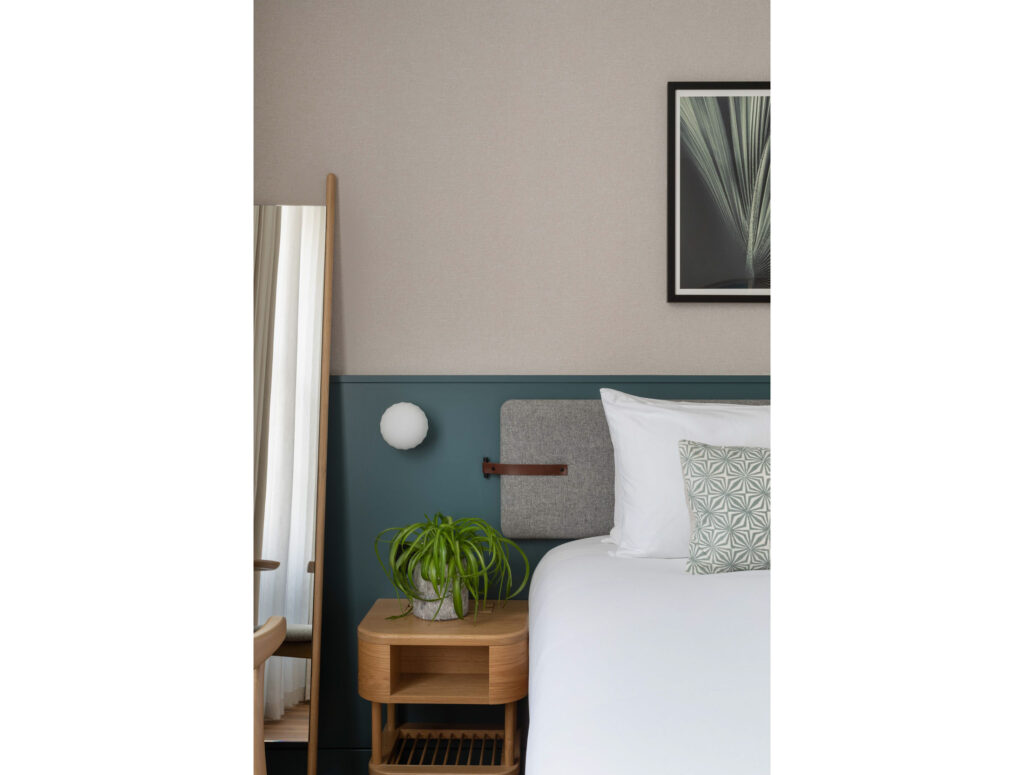 inhabit hotel bedroom with green and plant accents