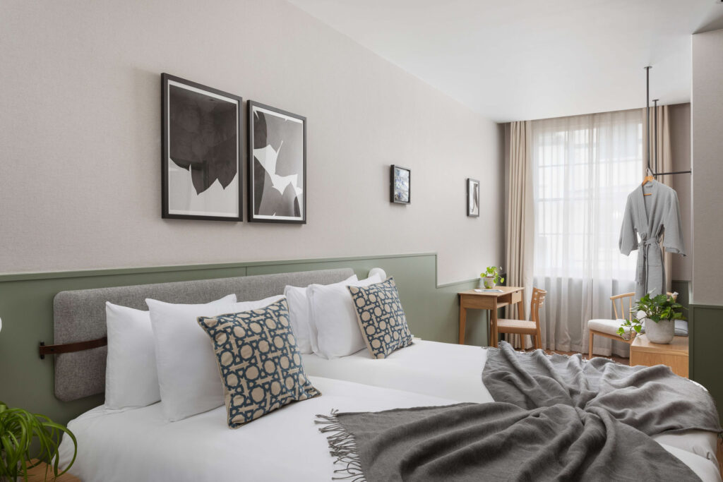 twin hotel bedroom with grey blanket