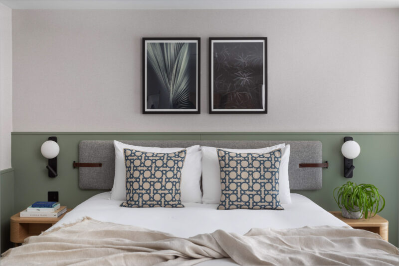 double hotel bedroom with cream features and green wall